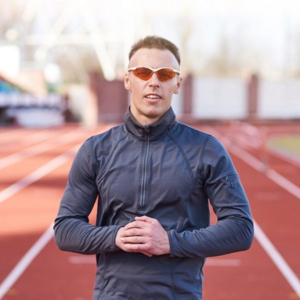 Uomo Atletico In Posa Sulla Pista Di Atletica Con Occhiali Da Corsa